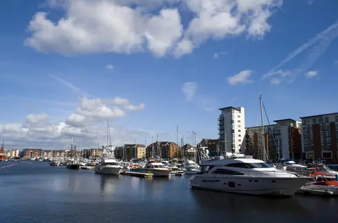 Boats moored in Swansea Marina with apartment blocks behind