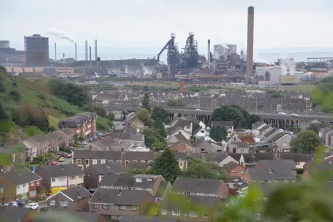 Houses in Port Talbot with the motorway and the steelworks behind